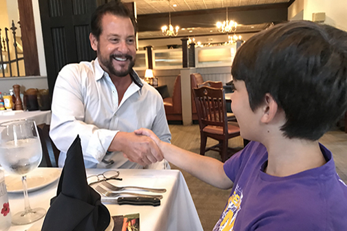 Al Copeland shakes Josh Bertuglia's hand at Copelands luncheon
